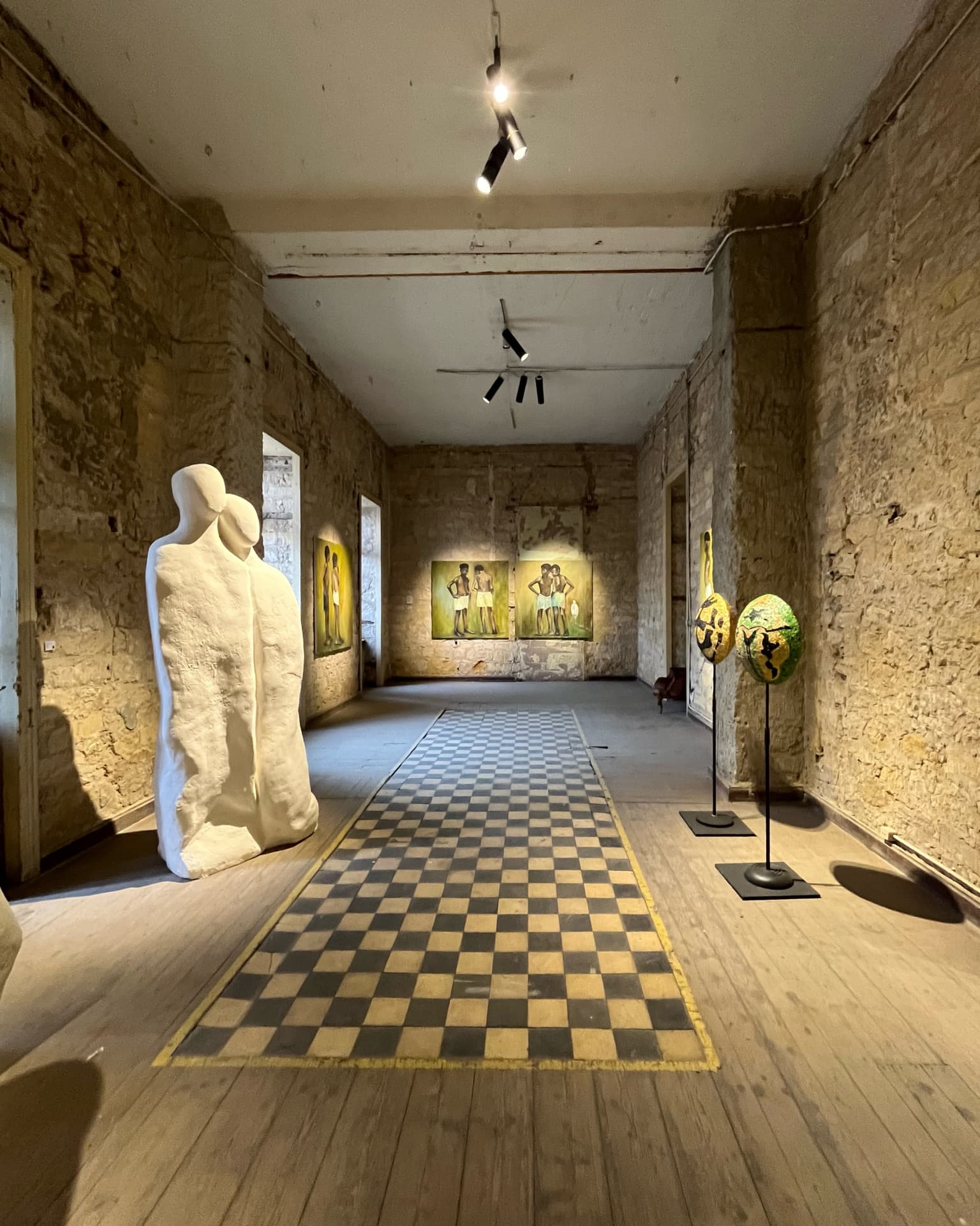 Wide gallery view of the Traces of Nubia exhibit with plaster figures and paintings